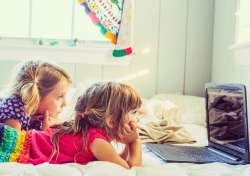 kids mindlessly watching something on a computer or tablet