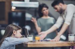 parents fighting in front of sad kid